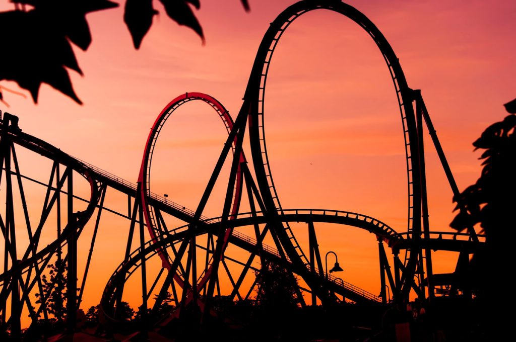 rollercoaster with red background to symbolize emotional rollercoaster for women