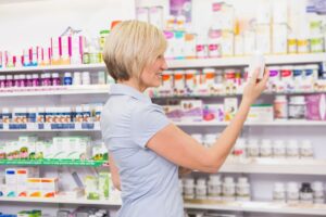 Woman shopping drugstore for supplements